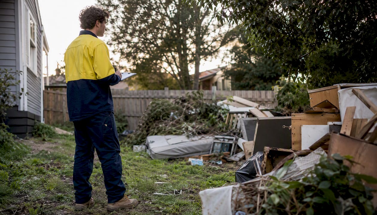 Professional assessing junk piles for onsite quote