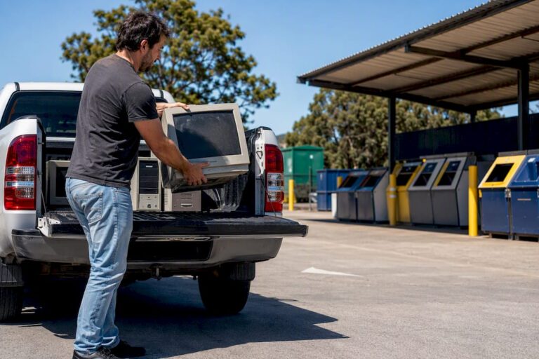 Person unloading old monitors at recycling centre