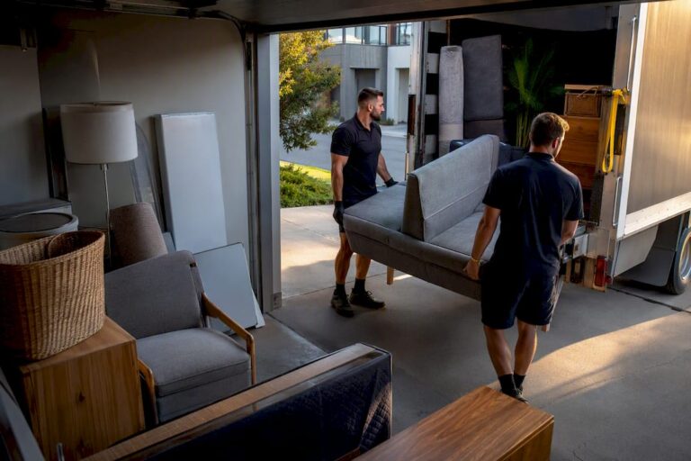 Crew loading bulky rubbish from townhouse garage