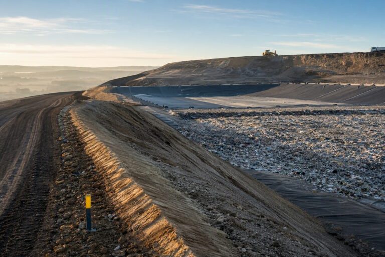 Engineered landfill cell beneath layered earth