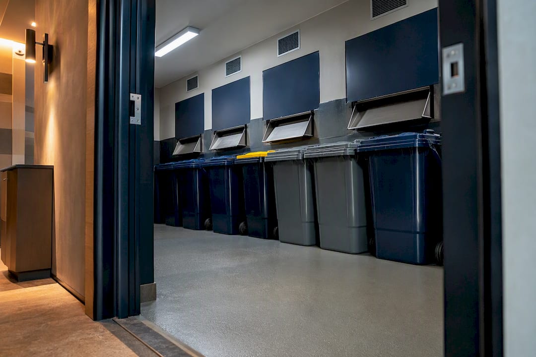 Apartment bin room with waste chutes