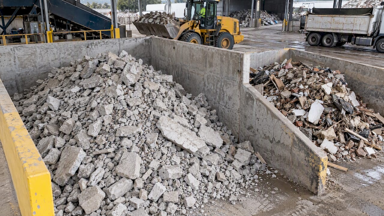 Separated concrete beside mixed construction debris